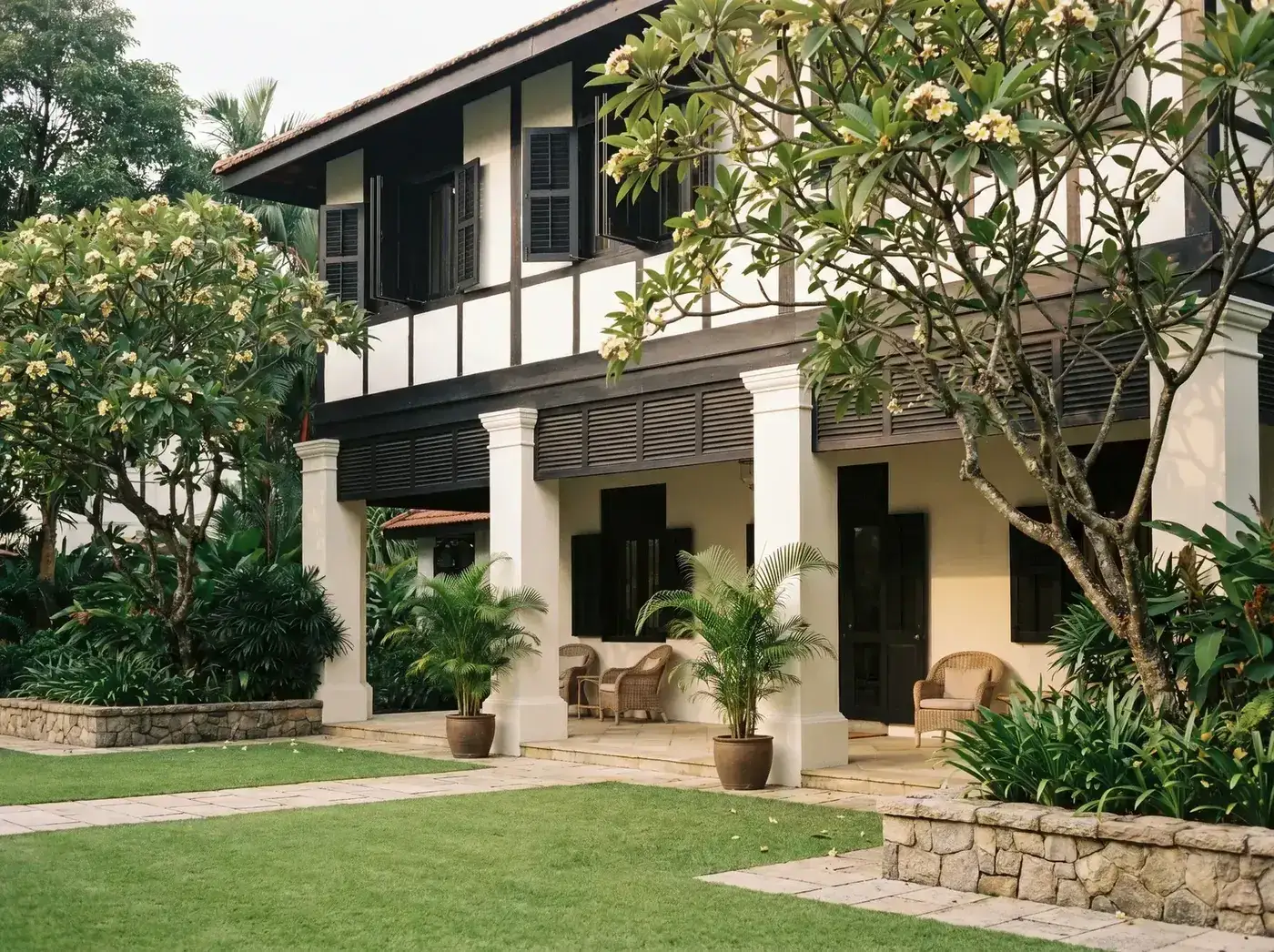 A semi-detached home set back from the road, mature planting at the frontage.